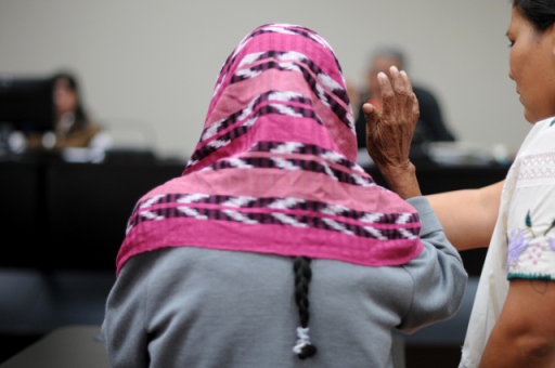 With her face covered, a survivor is sworn in by the court. Photo by Sandra Sebastián, via ACOGUATE